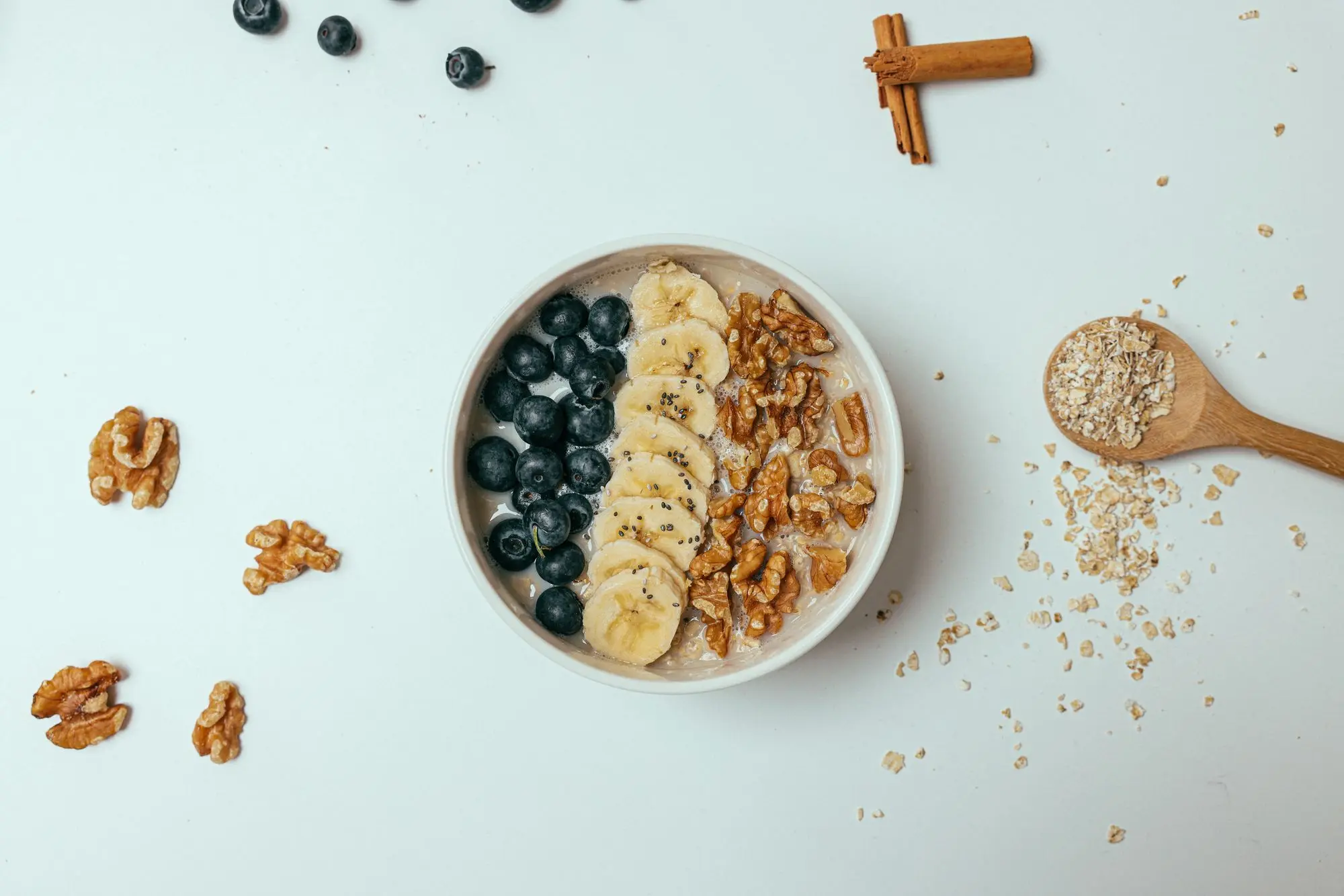 Haferbrei mit Banane, Blaubeeren, Walnüssen und Chiasamen in einer weißen Schale